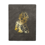 Black blanket with gold robot design on a white background