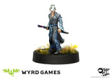 Figurine on a black base with 'Wyrd Games' branding